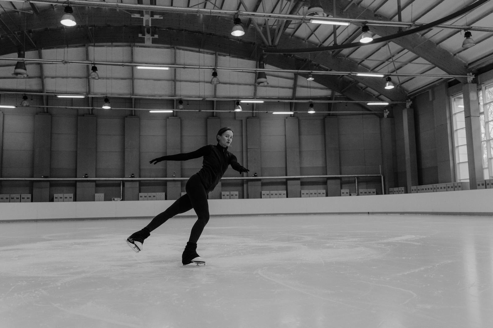 Man in Black Jacket and Pants Playing Basketball in Grayscale Photography