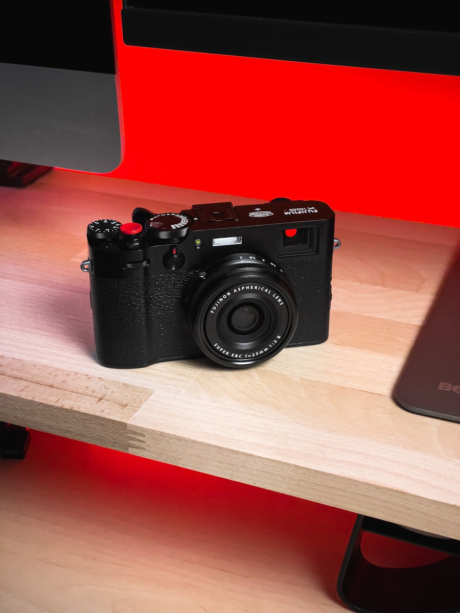 a camera sitting on a table next to a laptop